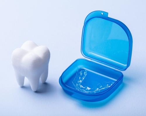 Tooth with night guard in blue case